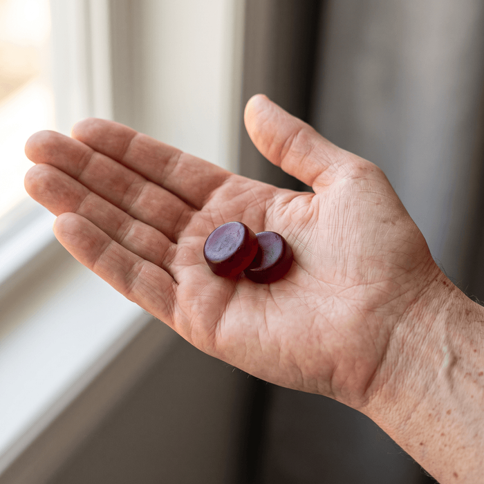 Two gummies in an open hand