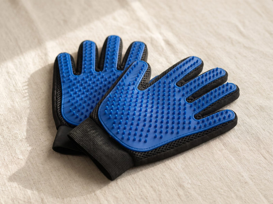 A pair of Quiet Hands grooming gloves, palm side up, showing the silicone tips