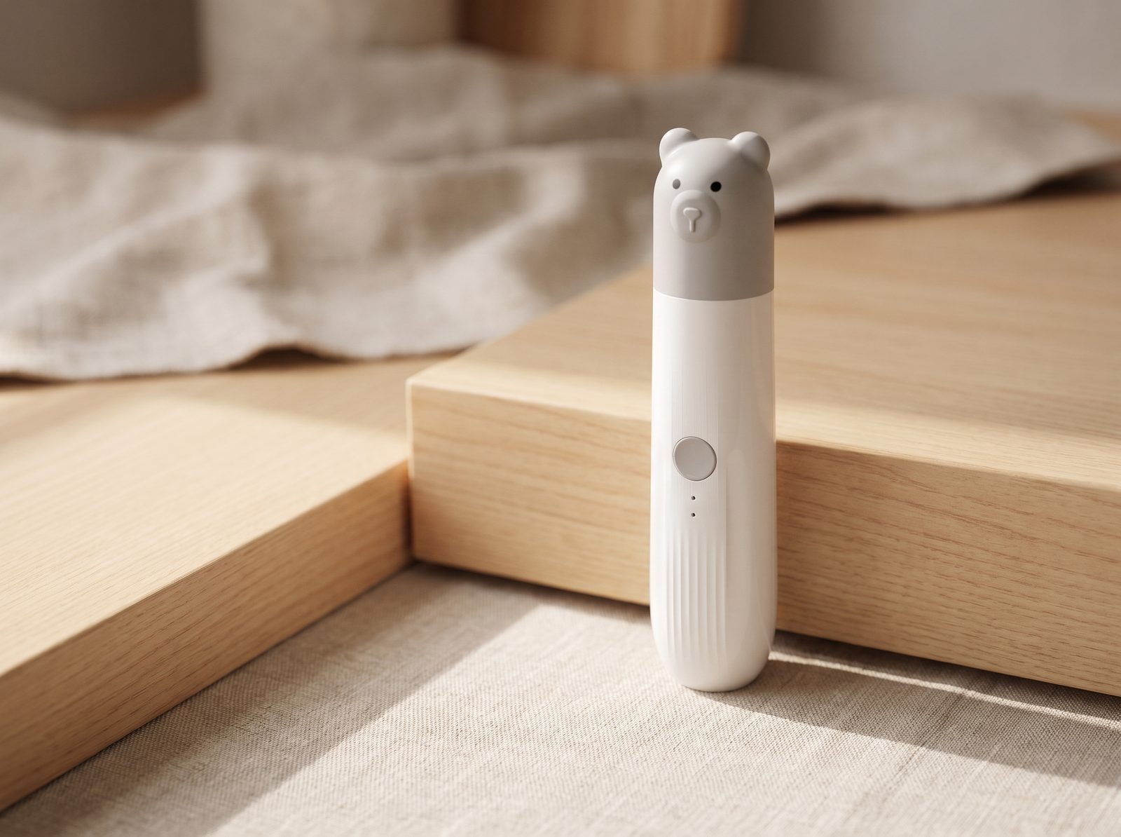 The Little One: a slim white grinder with a moulded grey bear-head cap